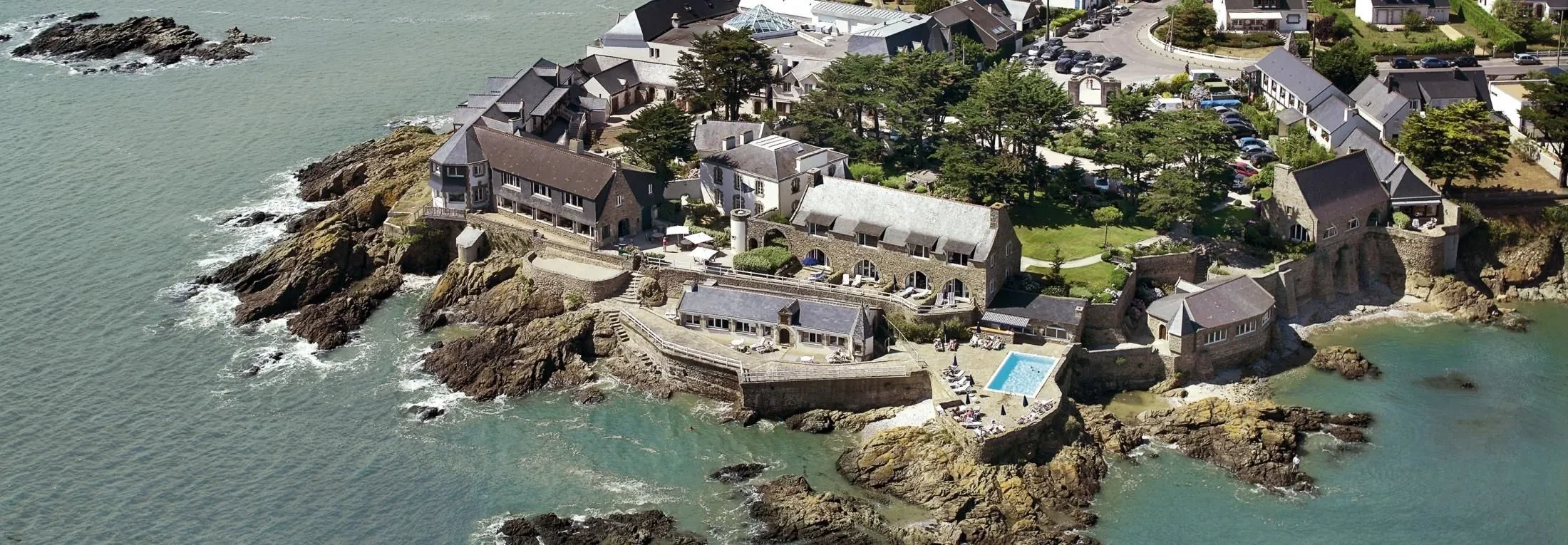 Vue aérienne d'un village côtier avec piscine. Séjour à Sarthe